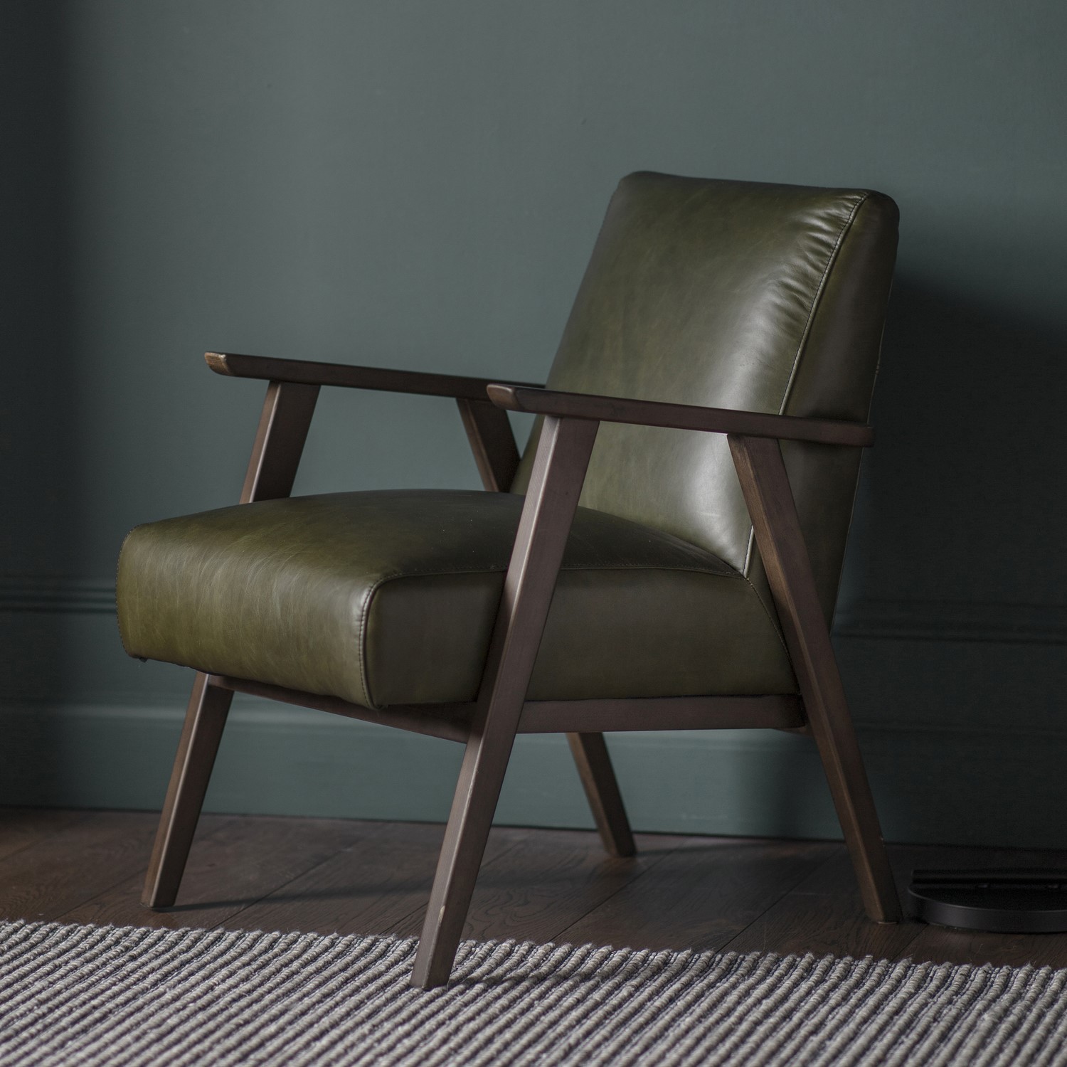 Photo of Green leather armchair with dark wood frame - caspian house