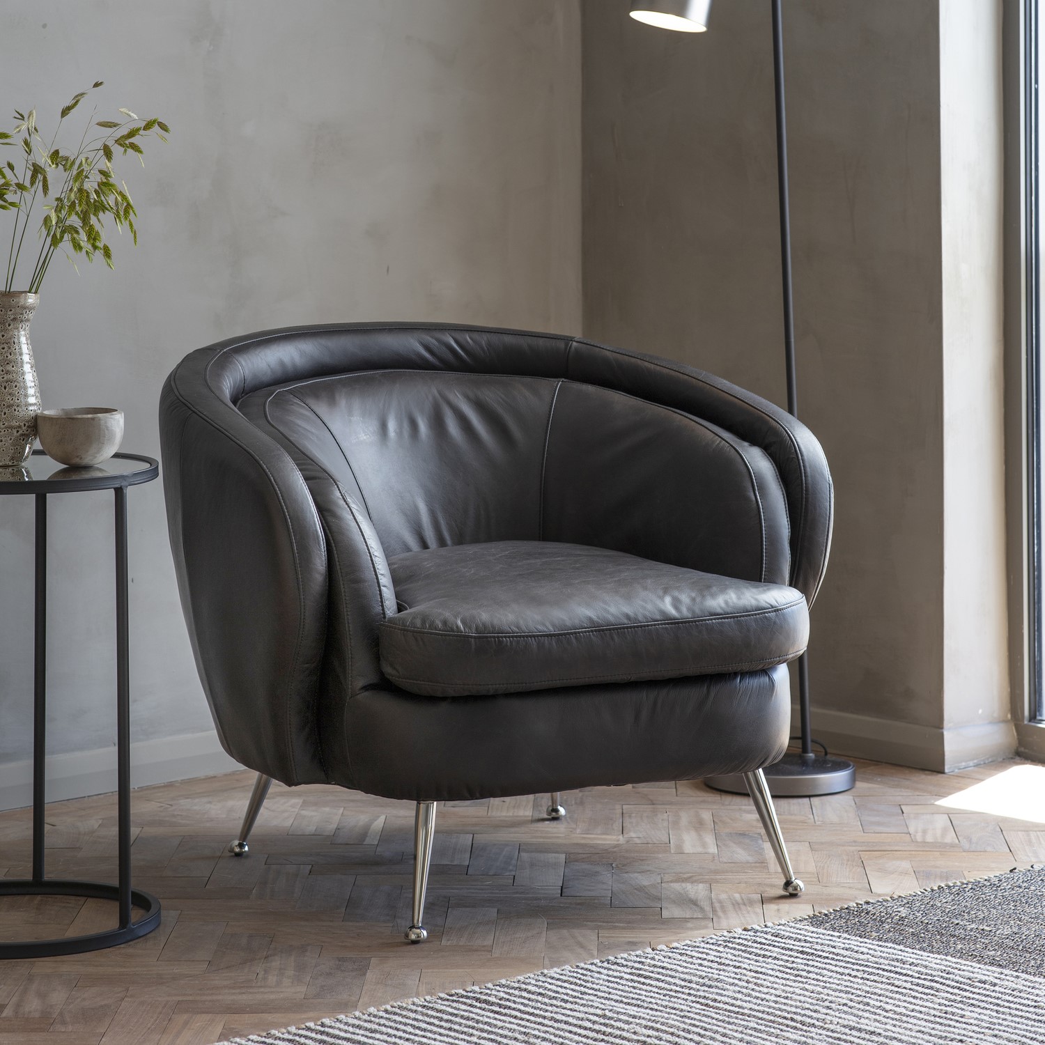 tub chair in black leather with metal legs caspian house