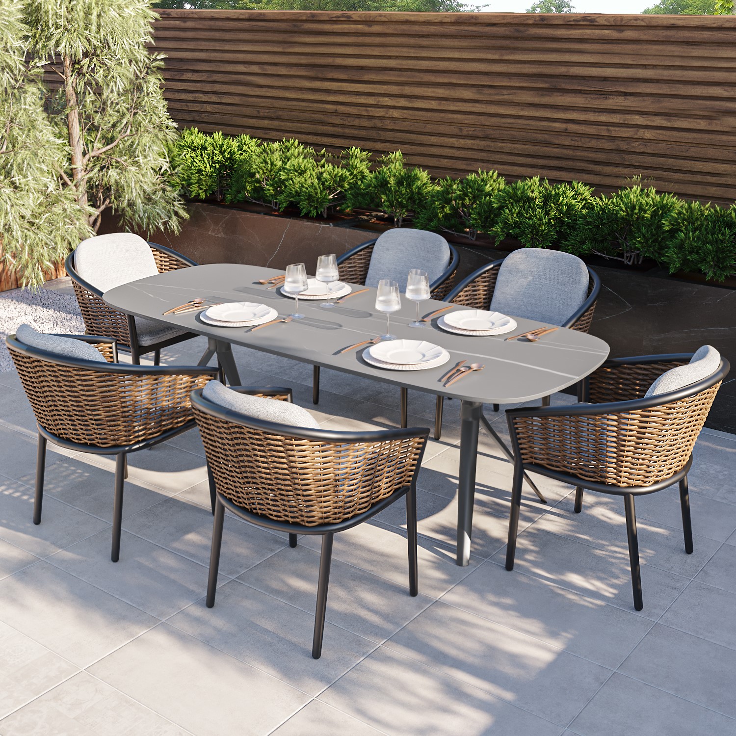 Photo of 6 seater garden dining set with woven wicker chairs & stone table top